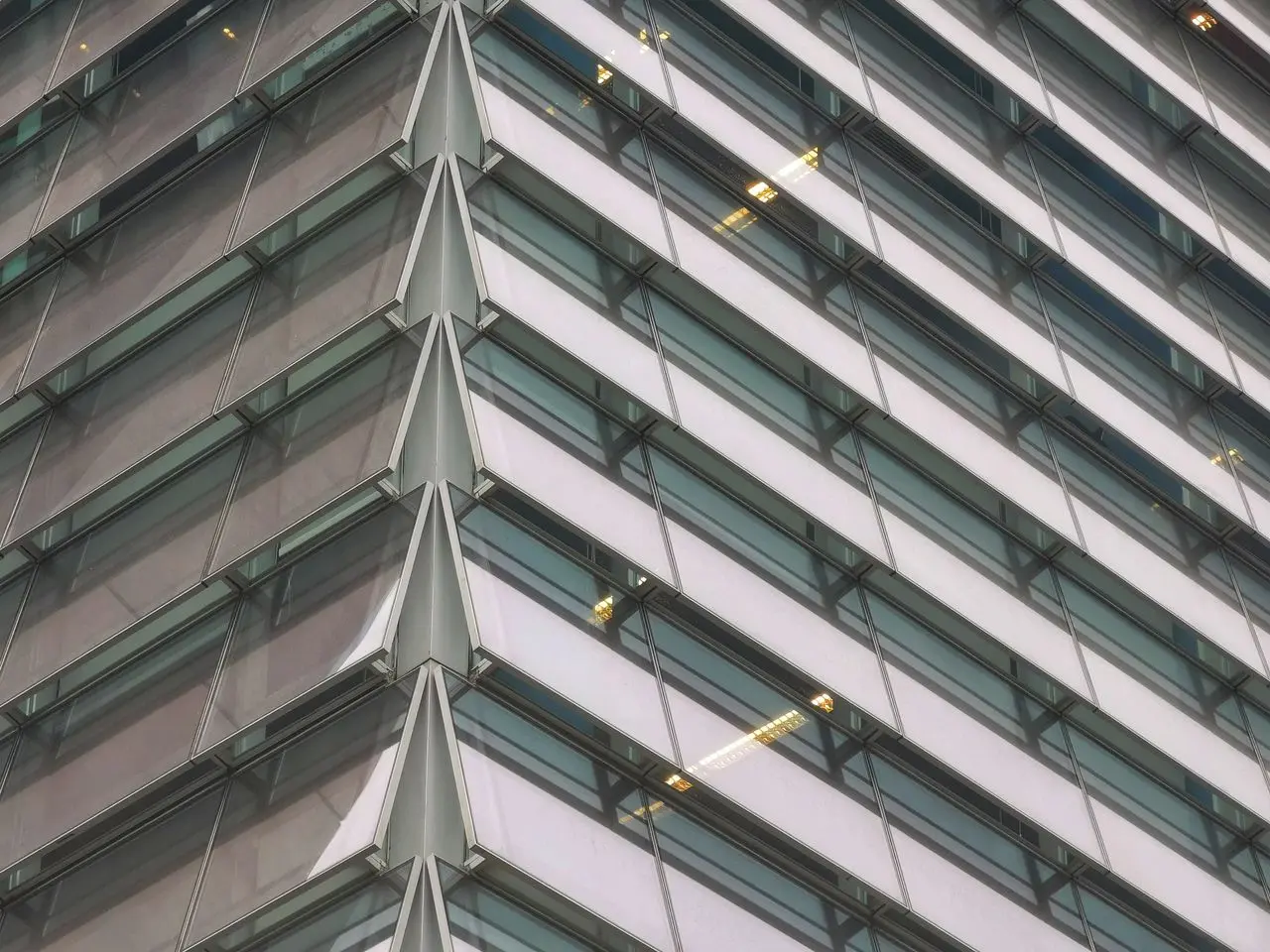 Geometric glass facade of a modern office building.